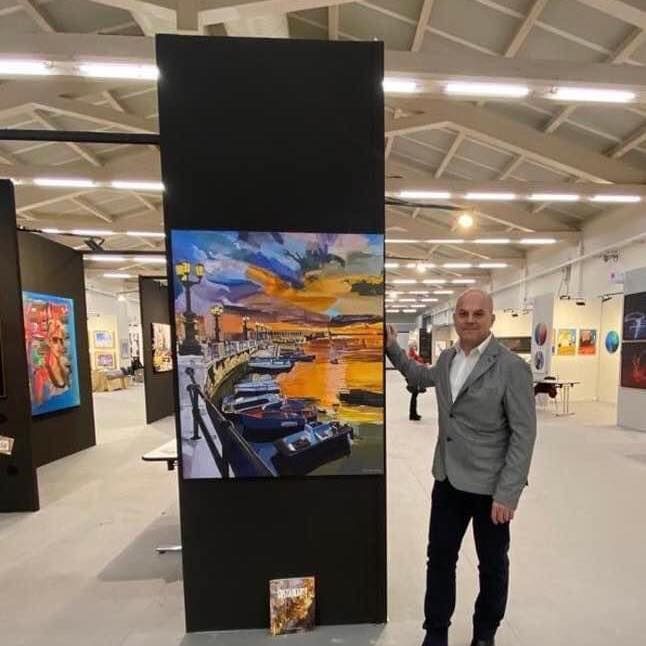 Alex Da Torres accanto alle sue opere in fiera